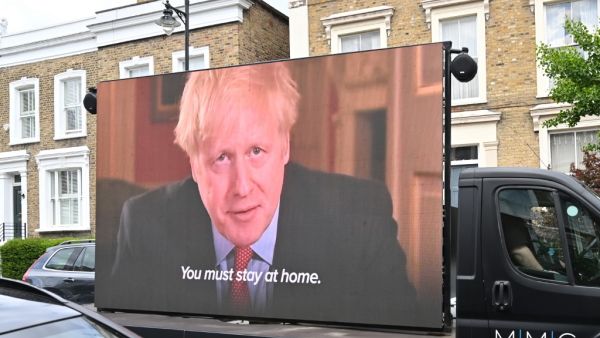A big screen organised by British political campaign group Led By Donkeys mounted on a vehicle plays a clip from Britain's Prime Minister Boris Johnson's March 23 address to the nation where he explained the stay-at-home coronavirus lockdown rules outside the home of Number 10 Downing Street special advisor Dominic Cummings in London on May 24, 2020 following allegations Cummings broke coronavirus lockdown rules by travelling across the country in March. British Prime Minister Boris Johnson was under increa