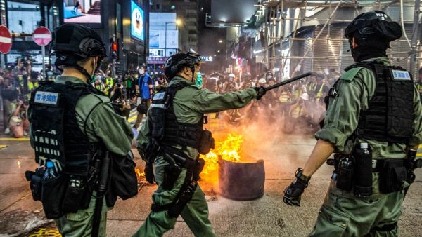Hong Kong police cast a dragnet around the financial hub's legislature on May 27, firing pepper-ball rounds and arresting hundreds as they stamped down on protests against a bill banning insults to China's national anthem. ISAAC LAWRENCE / AFP