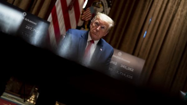 U.S. President Donald Trump listens as he attends a meeting with the Arkansas Governor Asa Hutchinson and Kansas Governor Laura Kelly in the Cabinet Room of the White House May 20, 2020 in Washington, DC. Doug Mills-Pool/Getty Images/AFP