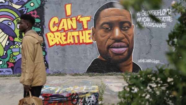 A graffiti depicting a portrait of George Floyd, a black man who died in Minneapolis after a white policeman kneeled on his neck for several minutes is seen in Berlin's Mauer Park on May 30, 2020. Odd ANDERSEN / AFP