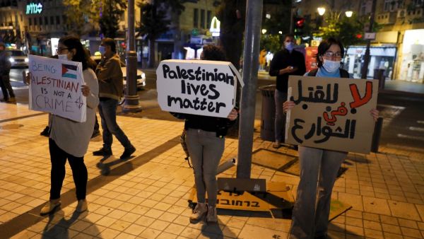 Israeli demonstrators carry placards during a demonstration condemning the shooting of Iyad Hallak, a disabled Palestinian man who was shot dead by Israeli police after they mistakenly thought he was armed with a pistol, in Jerusalem on May 30, 2020. Ahmad GHARABLI / AFP