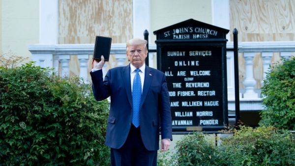 US President Donald Trump holds a Bible while visiting St. John's Church across from the White House after the area was cleared of people protesting the death of George Floyd June 1, 2020, in Washington, DC. US President Donald Trump was due to make a televised address to the nation on Monday after days of anti-racism protests against police brutality that have erupted into violence. The White House announced that the president would make remarks imminently after he has been criticized for not publicly addr