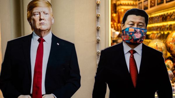 Cardboard figures of Chinese President Xi Jinping (R) wearing a face mask and US President Donald Trump (L) stand in front of a souvenir shop in downtown Moscow on June 3, 2020. (Dimitar DILKOFF / AFP)