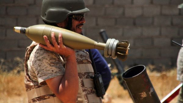 A fighter loyal to the UN-recognised Libyan Government of National Accord (GNA) holds a mortar shell amid clashes with rival forces loyal to strongman Khalifa Haftar near the capital Tripoli International Airport, on June 3, 2020. (AFP)
