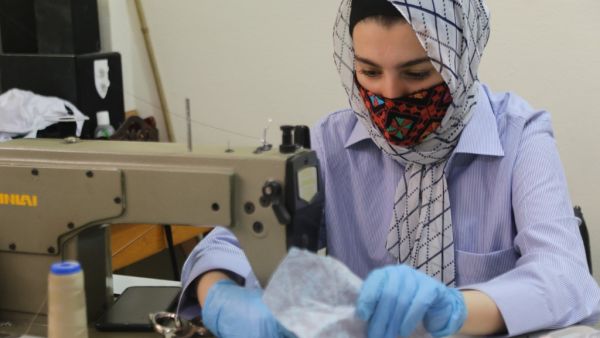 An Egyptian woman makes colourful bedouin-styled face masks on June 3, 2020 at the city of El-Arish, the capital of Egypt's North Sinai province, to be sold online to customers as part of COVID-19 coronavirus prevention. AFP