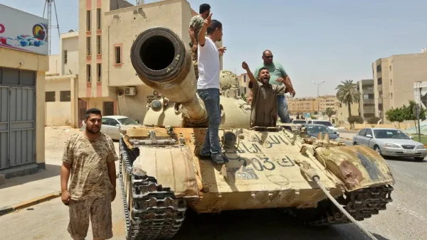 Fighters loyal to Libya's UN-recognised Government of National Accord (GNA) stand atop a tank in the town of Tarhuna, about 65 kilometres southeast of the capital Tripoli on June 5, 2020, after the area was taken over by pro-GNA forces from rival forces loyal to strongman Khalifa Haftar. Mahmud TURKIA / AFP