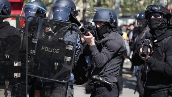 In this file photo taken on April 20, 2019 A police officer points a 40-millimetre rubber defensive bullet launcher LBD (LBD 40) during clashes at the Place de la Republique during an anti-government demonstration called by the 'Yellow Vests' (gilets jaunes) movement for the 23rd consecutive Saturday, on April 20, 2019 in Paris. The 2019 report of the General Inspectorate of the National Police (IGPN) notably publishes the number of dead (19) and seriously injured (117) during police interventions and revie
