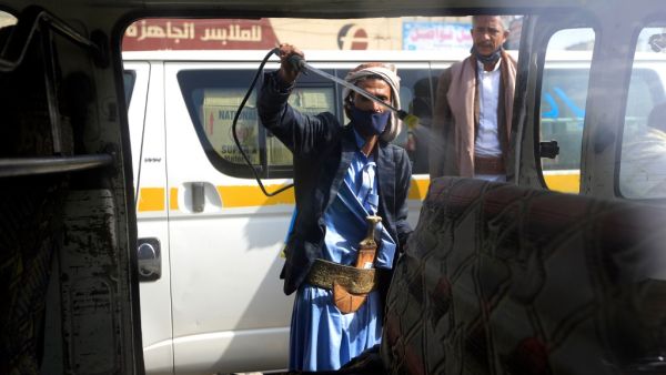 A Yemeni worker sprays disinfectant inside a van used for public transportation in the capital Sanaa, during the ongoing novel coronavirus pandemic crisis, on June 10, 2020. MOHAMMED HUWAIS / AFP