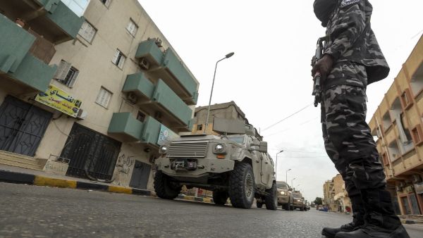 A member of security forces affiliated with the Libyan Government of National Accord (GNA)'s Interior Ministry stands as a security patrol advances in the town of Tarhuna, about 65 kilometres southeast of the capital Tripoli on June 11, 2020. Mahmud TURKIA / AFP