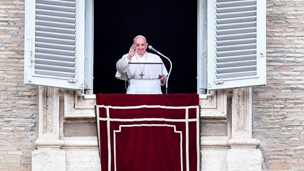 Pope Francis blesses attendees from the window of the Apostolic palace during the weekly Angelus prayer on June 14, 2020 in The Vatican, as the city-state eases its lockdown aimed at curbing the spread of the COVID-19 infection, caused by the novel coronavirus. Tiziana FABI / AFP