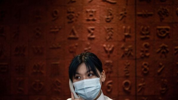 This photo taken on June 14, 2020 shows a staff member talking in the phone at Hubei Libruary as it reopens to the public in Wuhan in China's central Hubei province. STR / AFP