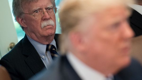 In this file photo US President Donald Trump speaks alongside National Security Adviser John Bolton (L) during a Cabinet Meeting in the Cabinet Room of the White House in Washington, DC, May 9, 2018. Donald Trump said on June 20, 2020 his former national security advisor John Bolton would pay a "big price" for what the president described as an illegal tell-all memoir. SAUL LOEB / AFP
