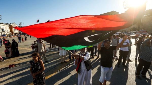 An elderly man waves a Libyan national flag during a demonstration in the Martyrs' Square in the centre of the Libyan capital Tripoli, currently held by the UN-recognised Government of National Accord (GNA), on June 21, 2020. The GNA on June 21 denounced Egypt's warning of military intervention in Libya, labelling it a "declaration of war", after the Egyptian President warned that if pro-GNA forces advanced on the strategic city of Sirte -- some 450 kilometres (280 miles) east of Tripoli -- it could provoke