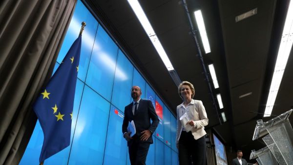 European Council President Charles Michel (R) and European Commission President Ursula von der Leyen leave after attending a news conference following a virtual summit with Chinese President in Brussels, on June 22, 2020. YVES HERMAN / POOL / AFP