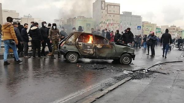 Iranian protesters gather around a burning car during a demonstration against an increase in gasoline prices in the capital Tehran, on November 16, 2019. AFP/Getty Images