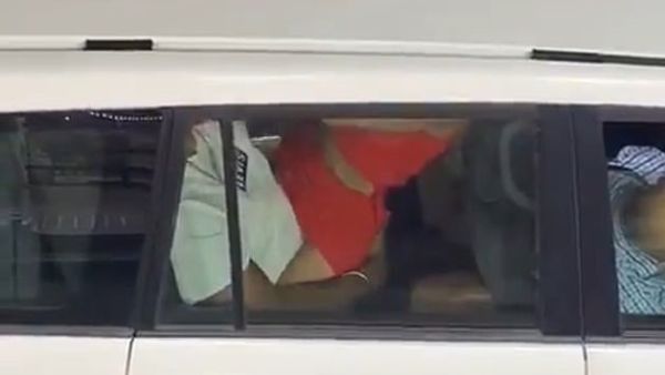In the 18-second video which was posted on Twitter, a man in the back seat of a white car marked with the UN letters is seen being straddled by a woman in a red dress who is moving up and down. In the front of the car, a male passenger appears to be asleep (Twitter)