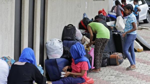 Ethiopian domestic workers who were dismissed by their employers gather with their belongings outside their country’s embassy in Hazmiyeh, east of Beirut, on June 24, 2020. - Around 250,000 migrants -- usually women -- work as housekeepers, nannies and carers in Lebanese homes, a large proportion Ethiopian and some for as little as $150 a month. None are protected by labour law. [Image: AFP]