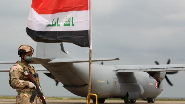 An Iraqi soldier stands guard near a U.S. military air carrier at the Qayyarah Airfield West, before the U.S. transferred the base to Iraqi forces in March. Ahmad Al-Rubaye/AFP via Getty Images