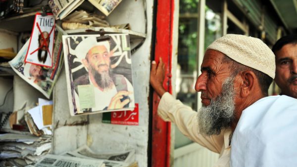 Pakistani man reading newspapers and daily life on May 15, 2011 in Abbottabad, Pakistan (Shutterstock)
