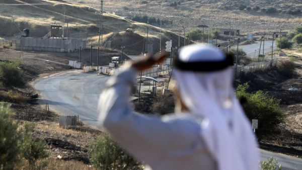 A Palestinian shepherd stands near the Israeli Hamra checkpoint, which separates the areas of the Palestinian Authority classified A and classified B in the Jordan Valley east of Nablus on July 1, 2020. The Oslo Agreements on self-rule signed by the Israelis and Palestinians in the 1990s divide the West Bank into Areas A, B and C. Area C, under full Israeli control, constitutes some 60 percent of the West Bank. The settlements and parts of the Jordan Valley that Israel seeks to annex are mainly in Area C. T