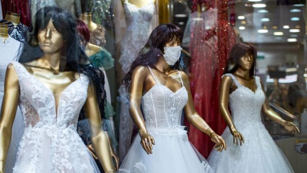 A picture taken on June 30, 2020 in Istanbul shows mannequins wearing wedding dress with matching protective mask displayed in a store amid the novel coronavirus (COVID-19) pandemic. (AFP)
