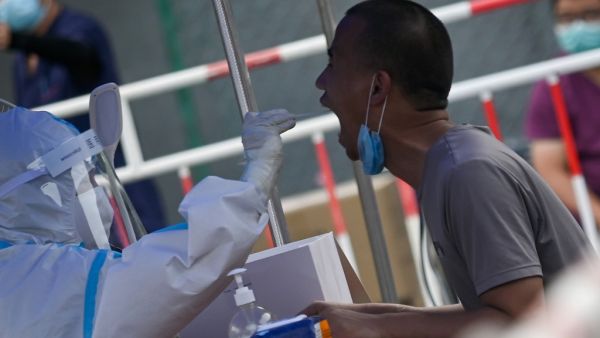 A man receives a swab test during widespread testing for the COVID-19 coronavirus outbreak in Beijing on July 1, 2020. WANG Zhao / AFP