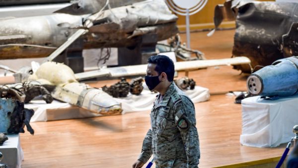 Royal Saudi Air Force Colonel Turki bin Saleh al-Malki walks past alleged Iranian weapons seized by Saudi forces from Yemen's Huthi rebels, ahead of a press conference at the Armed Forces Oficers club in Saudi Arabia's capital Riyadh on July 2, 2020, after air strikes on the rebel-held Yemeni capital. FAYEZ NURELDINE / AFP