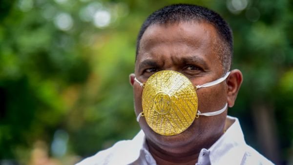 Businessman Shankar Kurhade wears a facemask made of gold and being worth 289,000 rupees amid concerns over the COVID-19 coronavirus outbreak, in Pune on July 4, 2020. Sanket WANKHADE / AFP