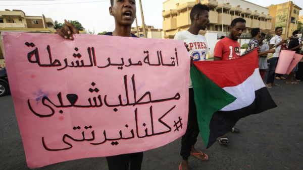 A demonstrator stands with a sign reading in Arabic "sacking the chief of police is a popular demand #WeAreAllNertiti", during a protest outside the Sudanese Professionals Association in the Garden City district of Sudan's capital Khartoum on July 4, 2020, in solidarity with the people of the Nertiti region of Central Darfur province in the country's southwest. ASHRAF SHAZLY / AFP