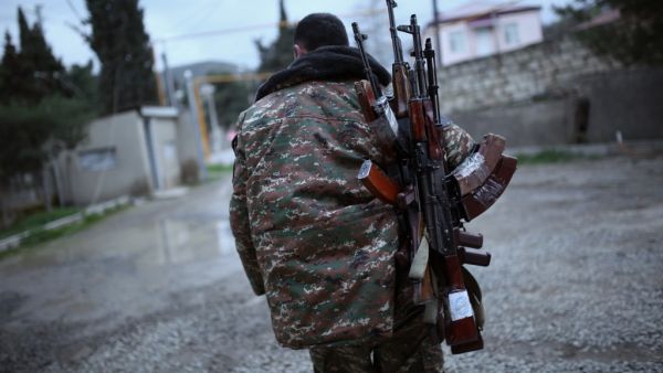 In this file photo taken on April 4, 2016, a soldier of the self-defence army of Nagorno-Karabakh carries weapons in the Martakert region. Azerbaijan on July 7, 2020, raised the spectre of a fresh war with arch-foe Armenia and denounced stalled peace talks over the disputed Nagorny Karabakh region. The two ex-Soviet republics have for decades been locked in a simmering conflict over the breakaway territory, which was at the heart of a bloody war in the 1990s. Vahan Stepanyan / PAN Photo / AFP