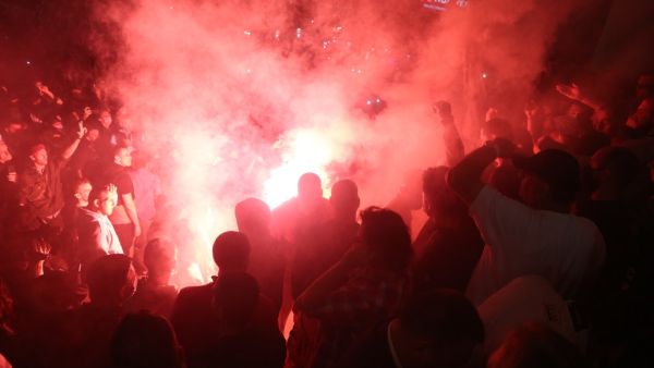 The demonstrators, who also lit flares and were seen throwing stones at police on local TV, chanted for President Aleksandar Vucic to "Resign!". OLIVER BUNIC / AFP