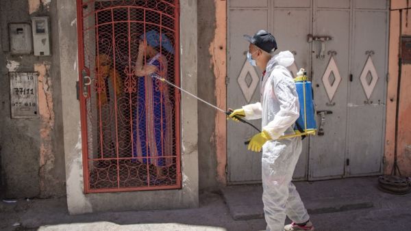 A Moroccan municipal worker disinfects outside a house in a closed street in the southern port city of Safi on June 9, 2020 after Moroccan authorities declared a total lockdown following the discovery of many new COVID-19 coronavirus cases there at a fish canning factory. FADEL SENNA / AFP