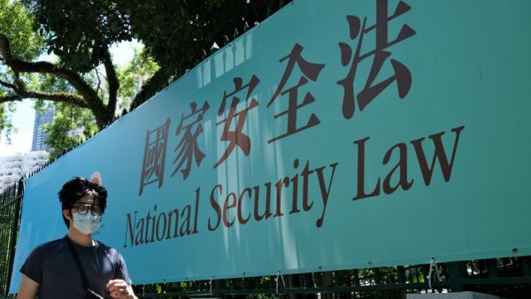 A man walks past a government public notice banner for the National Security Law in Hong Kong on July 15, 2020. Anthony WALLACE / AFP
