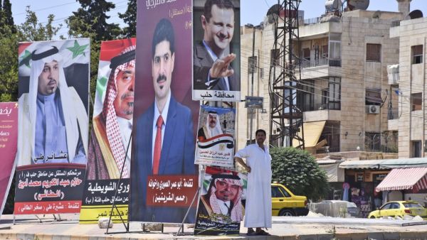 Campaign posters of candidates for the upcoming Syrian parliamentary election are displayed in the northern city of Aleppo, on July 15, 2020. AFP