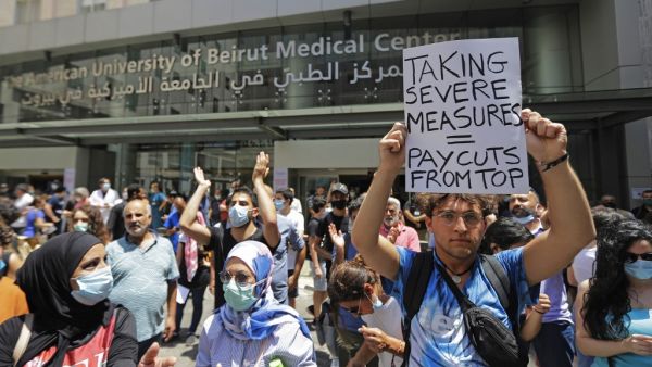 Lebanese activists demosntrate along with former employees of the American University Medical Center outside the hospital in the capital Beirut, on July 20, 2020. (JOSEPH EID / AFP)