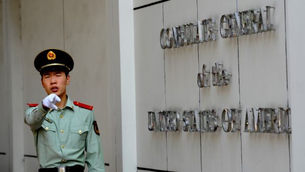 This file photo taken on September 18, 2012 shows a Chinese paramilitary policeman gesturing to photographers at the entrance to the US consulate in Chengdu, southwest China's Sichuan province. China said on July 24, 2020 it had revoked the license for the US consulate in the southwestern city of Chengdu, in retaliation for the closure of China's Houston consulate earlier this week. GOH Chai Hin / AFP