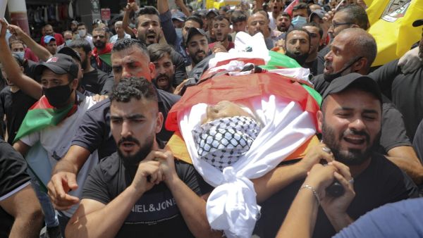 Palestinians carry the body of the local Fatah movement commander Imad Eddin Dweikat, who died in an altercation with Palestinian security forces last week, during his funeral in Balatah al-Balad, a suburb the city of Nablus in the Israeli-occupied West Bank, on July 27, 2020. JAAFAR ASHTIYEH / AFP