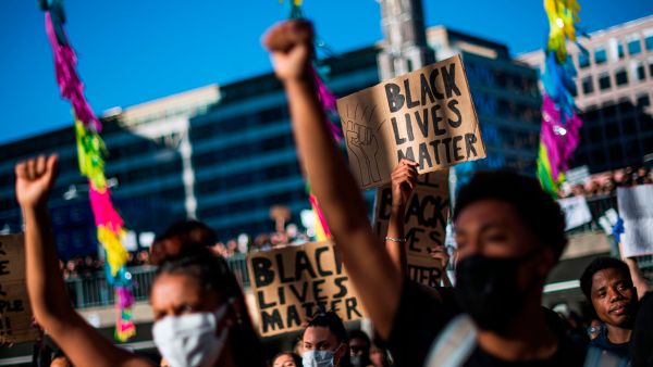 Protesters raise their fists during a Black Lives Matter demonstration in Stockholm, Sweden, June 3, 2020. (AFP)