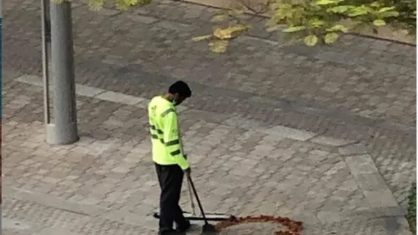 A photo of a Dubai cleaner crafting a heart out of some twigs, dried leaves he had collected while sweeping the street has gone viral on social media. (Twitter)