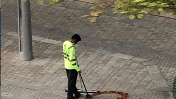A photo of a Dubai cleaner crafting a heart out of some twigs, dried leaves he had collected while sweeping the street has gone viral on social media. (Twitter)