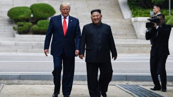 North Korea's leader Kim Jong Un walks with US President Donald Trump north of the Military Demarcation Line. (File Photo | AFP)