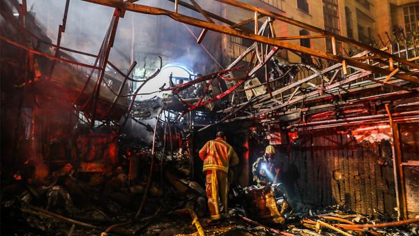 Firemen search for survivors at the scene of an explosion at the Sina At'har health center north of Tehran on June 30, 2020. Photo: Amir Kholousi / ISNA / AFP