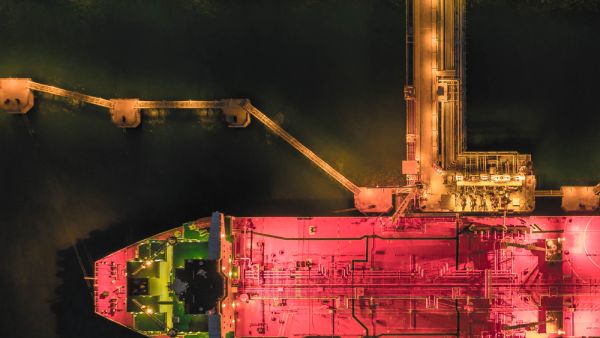 Aerial view oil tanker ship at the port at night, transportation and import export business (Shutterstock)