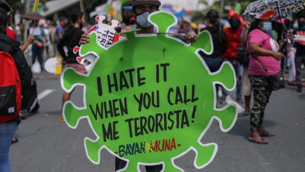 A protester carries a placard during a march towards the state university grounds for a rally in Manila on July 27, 2020, ahead of Philippine President Rodrigo Duterte's annual State of the Nation Address in congress. Maria TAN / AFP