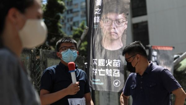  this file photo taken on July 11, 2020, pro-democracy activist Joshua Wong (C), a candidate of Kowloon East constituency, campaigns during a primary election to select the pro-democracy opposition candidates for election to the city's legislative council in September, in Hong Kong. (AFP/File)