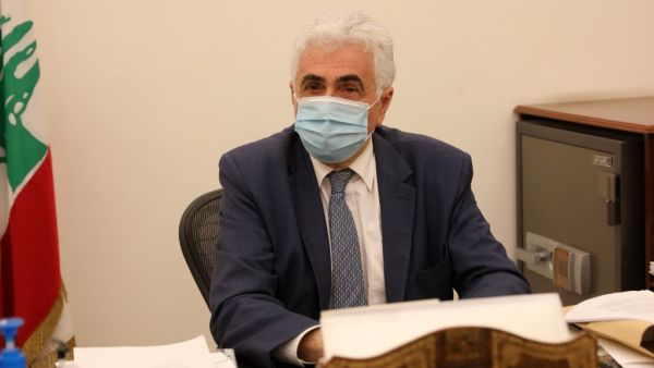 Lebanon's Foreign Minister Nassif Hitti is pictured wearing a face mask due to the coronavirus in his office in the capital Beirut, on August 3, 2020. Hitti announced his resignation today due to the government's mishandling of the country's worst crisis in decades, as premier Hasan Diab's under-fire cabinet struggles to secure international support. ANWAR AMRO / AFP