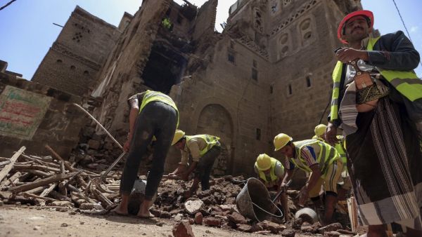 Yemeni labourers remove the rubble ahead of restoration works on the site of a collapsed UNESCO-listed building following heavy rains, in the old city of the Yemeni capital Sanaa, on August 12, 2020. Mohammed HUWAIS / AFP