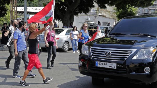 Lebanese anti-government protesters attack a vehicle belonging to a member of the parliament upon his arrival to the parliamentary session at the UNESCO Palace in Beirut, on August 13, 2020. ANWAR AMRO / AFP