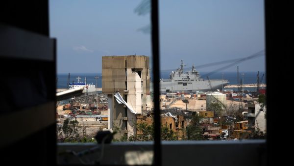 The French Navy amphibious assault helicopter carrier Tonnerre, docked at the Beirut port, is pictured from a damaged apartment in the neighbourhood of Mar Mikhael on August 14, 2020, more than a week after a massive blast ravaged the port and parts of the Lebanese capital. The catastrophic Beirut explosion on August 4 killed 171 people, injured thousands and laid waste to whole neighbourhoods. PATRICK BAZ / AFP