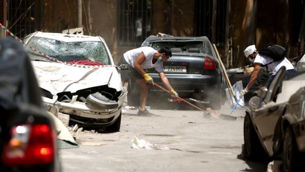Volunteer clear the rubble in the Beirut neighbourhood of Mar Mikhael on August 14, 2020, more than a week after a massive blast ravaged the port and parts of the Lebanese capital. The catastrophic Beirut explosion on August 4 killed 171 people, injured thousands and laid waste to whole neighbourhoods. PATRICK BAZ / AFP